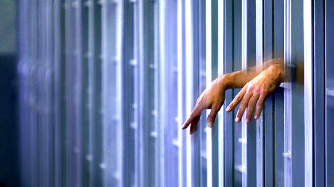 prison bars hands.jpg